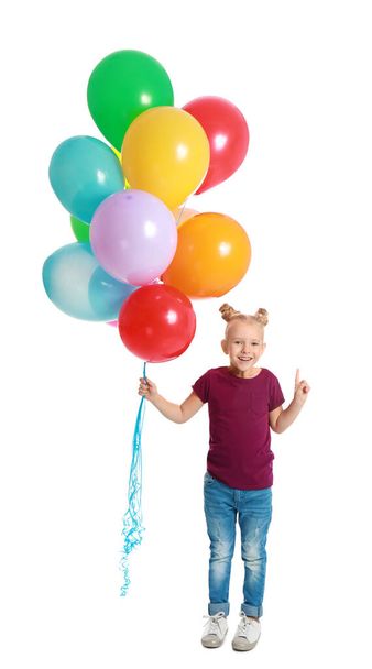 Little girl holding bunch of colorful balloons on white background - Foto, imagen