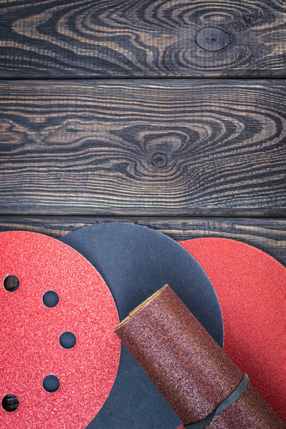 Set of abrasive tools and sandpaper on black vintage wooden background. - Photo, Image