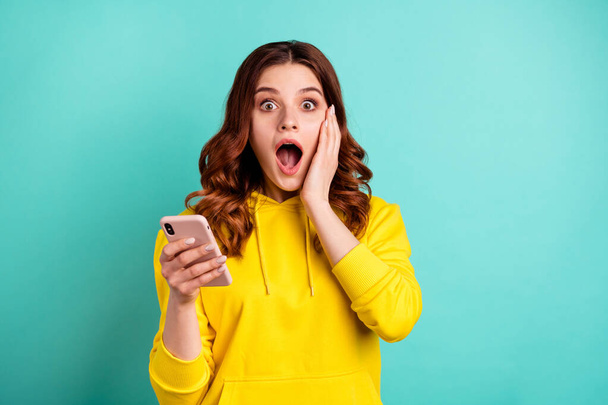 Photo of beautiful attractive charming cheerful nice cute pretty sweet young girl shocked with new information about sales wearing yellow sweater isolated over vivid color bright background - Fotoğraf, Görsel