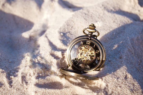Retro watch on sand. Time concept - Photo, Image
