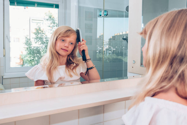routine mattutina in bagno spazzolando i capelli lunghi - Foto, immagini
