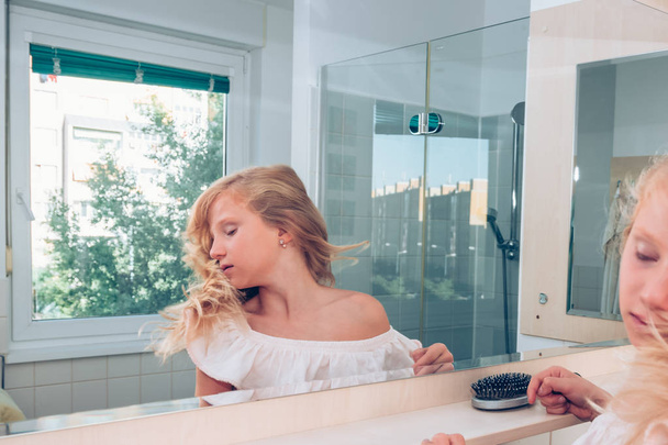 charming blond girl in front of in the mirror - Photo, Image