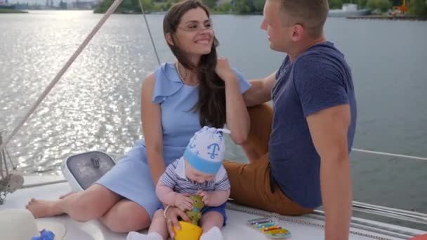 happy woman with good spouse and child at sailing yacht, tender kiss husband and wife on yacht, lucky childhood - Footage, Video