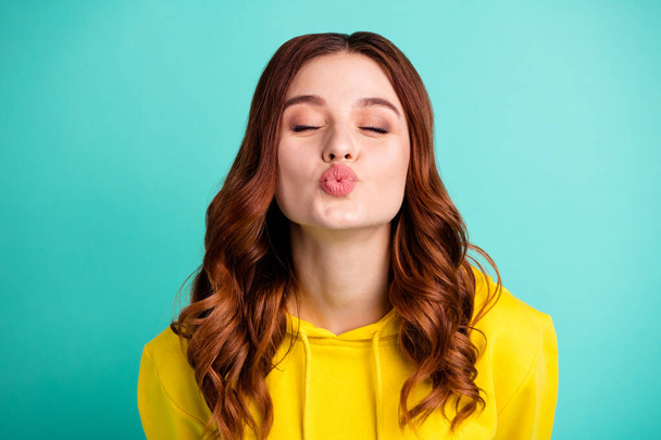Photo of cute nice beautiful tender soft youngster kissing you through camera with eyes closed inspired facial expression isolated over turquoise bright color background - Foto, immagini