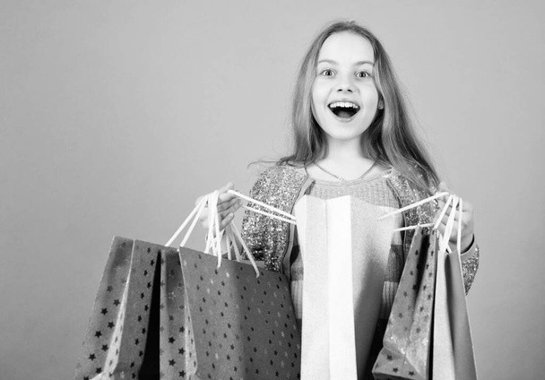 Fashion trend. Fashion shop. Little girl with bunch packages. Seasonal sale. Fashion girl customer. Happy child in shop with bags. Shopping day happiness. Birthday girl shopping. Fashion boutique - Valokuva, kuva