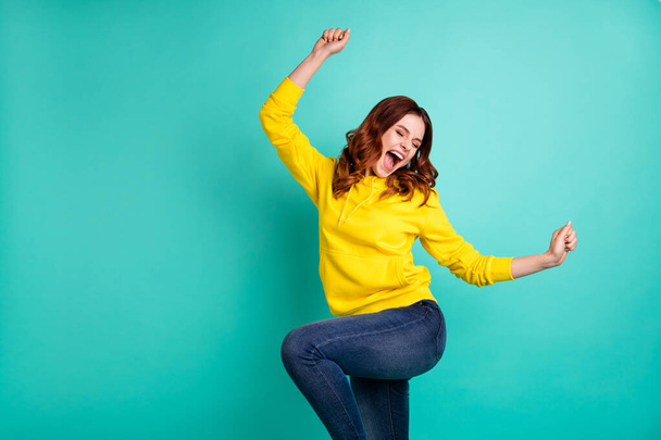 Photo of curly wavy trendy cheerful nice rejoicing fascinating girlfriend wearing jeans denim shouting dancing with victory isolated over teal vivid color background - Фото, зображення
