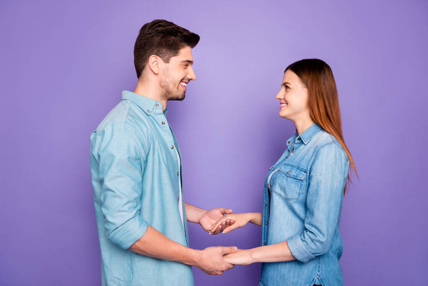 Profile side photo of romantic married couple hold hands have date feel romance enjoy holidays wear good-looking clothes isolated over purple violet color background - 写真・画像