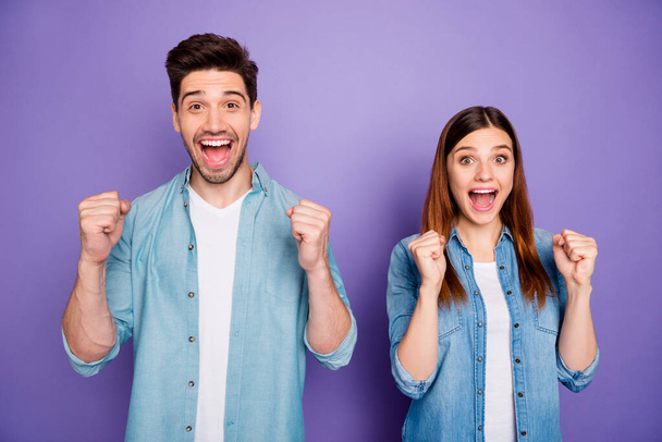 Portrait of funny funky romantic couple feel lucky raise fists scream yeah wear style stylish clothes isolated over purple violet color background - Photo, image