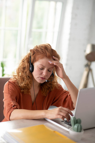 Freelancer sitting in front of computer having strong headache - Φωτογραφία, εικόνα
