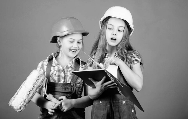 Kids choosing paint colour for their new room. Children sisters run renovation their room. Amateur renovation. Sisters renovating home. Home improvement activities. Kids girls planning renovation - Фото, изображение