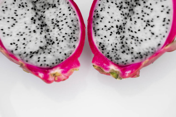 Dragon fruit. Vibrant Dragon Fruit on white background. Sliced white dragon fruit or pitaya on white plate on the table, close-up. Tropical and exotic fruits. Healthy and vitamin food concept. - Photo, Image