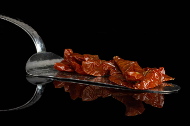 Dry red cherry tomato isolated on black glass - 写真・画像