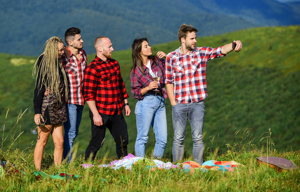 What is our next travel destination. happy men and girls friends make selfie. friendship. romantic picnic in tourism camp. summer vacation. group of people spend free time together. hiking adventure - Valokuva, kuva
