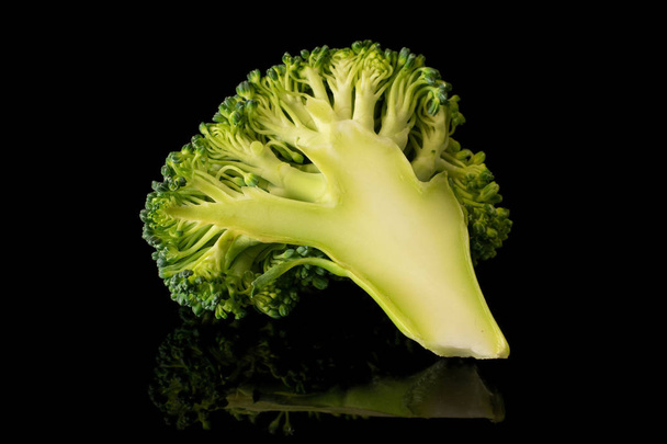 Fresh breen broccoli isolated on black glass - Fotó, kép