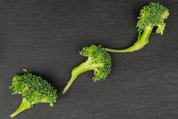 Fresh breen broccoli on grey stone - Zdjęcie, obraz