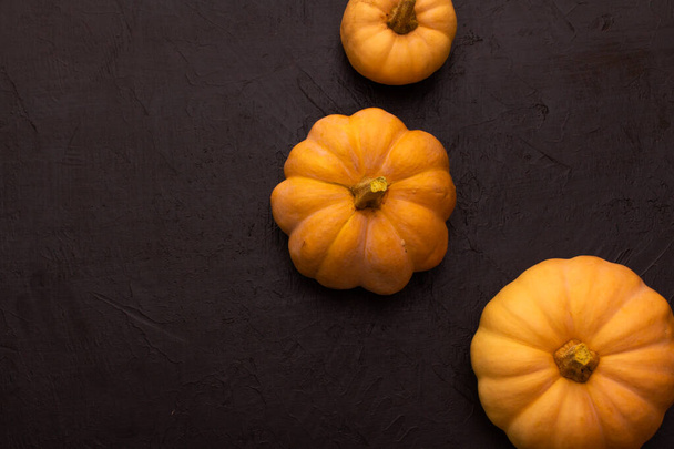 Pumpkins on black table. Halloween background - Photo, Image