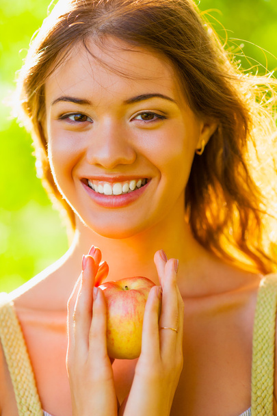 Closeup girl portrait holding apple - Photo, Image
