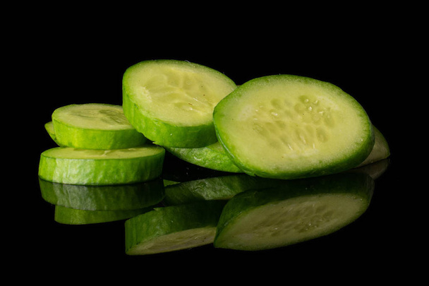 Fresh mini cucumber isolated on black glass - Photo, image