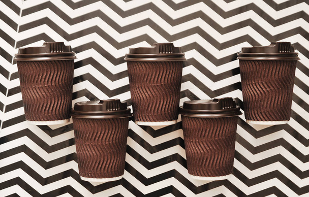 Бумажные чашки кофе на абстрактном красочном фоне
. - Фото, изображение