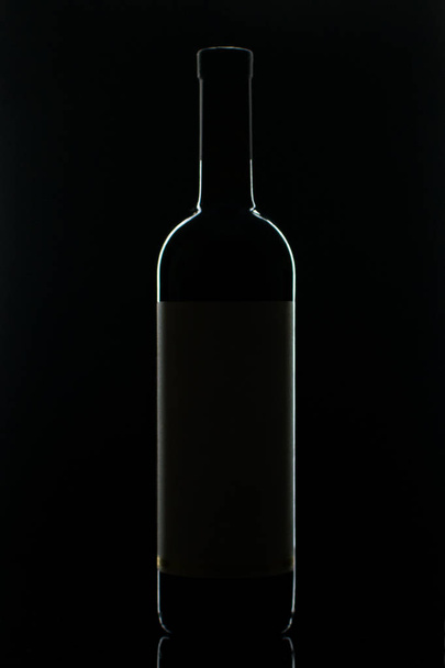 A bottle of red wine  - Foto, afbeelding