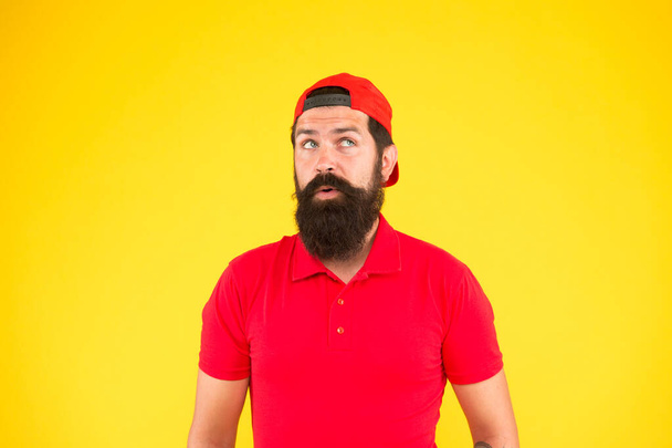 Give me a second. Supermarket staff wanted. Man bearded hipster with mustache wear uniform yellow background. Shop staff concept. Salesman career. Hiring shop store worker. Hospitality staff - Foto, imagen