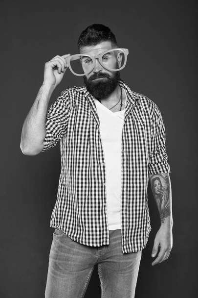 Funny hipster in extravagant glasses. Fashion man with beard. Playful guy enjoying party. Funny glasses accessory. Entertaining himself. Only fun on my mind. Bearded man wearing party glasses - Zdjęcie, obraz