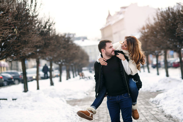 young loving couple on natural winter background. New Year and Christmas. - Zdjęcie, obraz