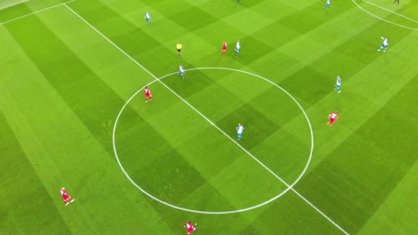 Aerial view of football players at kick-off of the match. Taken by drone - Footage, Video