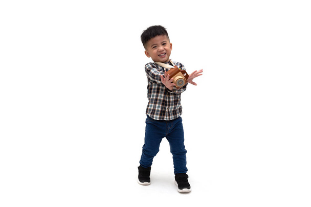 Attractive Asian little boy photographer wearing striped shirt standing  - Фото, зображення