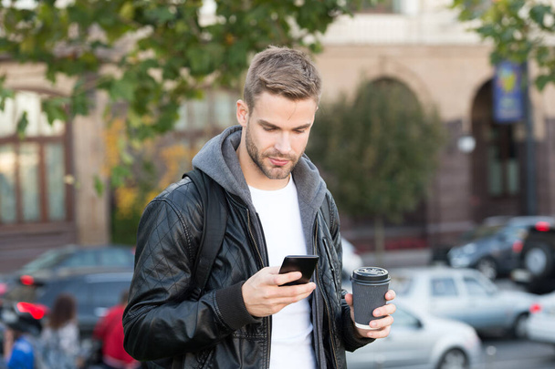 Social networks. Send message. Modern life impossible without online communication. Modern guy with smartphone urban background. Handsome man with mobile phone and coffee cup. Modern technology - Foto, Imagem