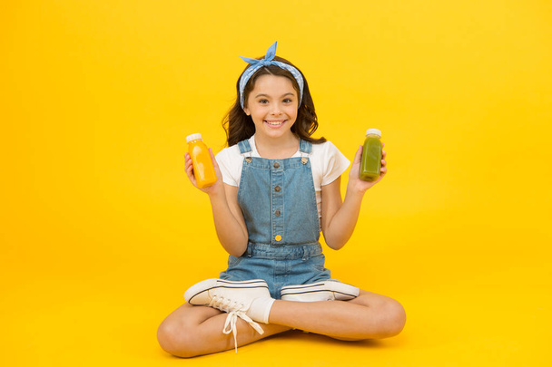 Купить диетическую еду. Счастливый маленький ребенок держит бутылки с диетической пищей. Маленькая девочка наслаждается натуральной диетой. Почувствуйте себя сытым и заряженным диетической едой. Здоровое питание. Питание и здравоохранение
 - Фото, изображение