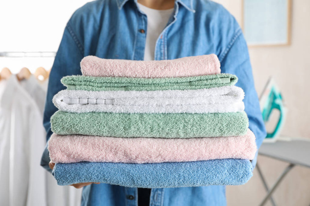 Young woman hold clean towels, close up and space for text - Photo, Image