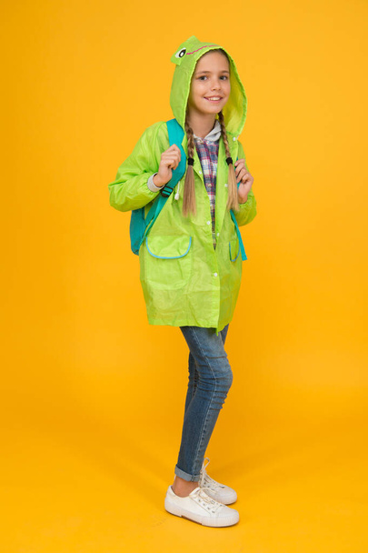 Waterproof cloak. Waterproof fabric for your comfort. Rainproof accessory. Schoolgirl hooded raincoat enjoy rainy weather. Waterproof clothes every kid should try. Kid girl happy wear raincoat - Photo, image