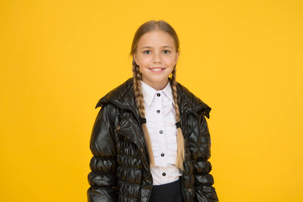 Keep her warm and dry whatever the weather. Happy child on yellow background. Autumn look of little girl child. Fashion child smile in casual style. Cute small child smiling with long blond hair - Фото, изображение