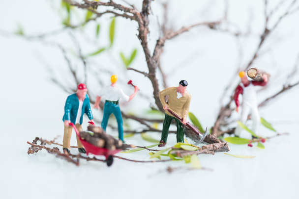 Miniature workmen cutting and felling trees close up - Photo, Image