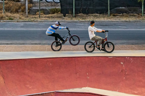 Cyclist jumping on bicycle. BMX rider. Boy doing tricks in the air on bike. Freestyle. The concept of skate culture and youth leisure. - Photo, Image