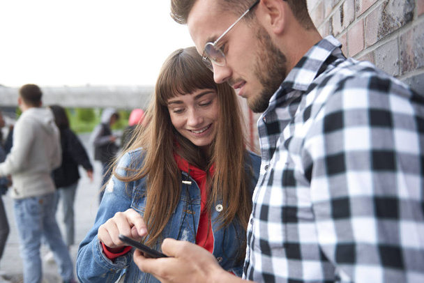 Young couple looking at mobile phone  - Photo, Image