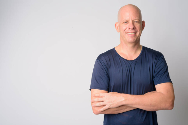 Portrait of happy mature handsome bald man smiling with arms crossed - Photo, Image
