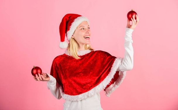 Girl happy wear santa costume celebrate christmas hold ball decor pink background. Merry christmas and happy new year. Christmas preparation concept. Lets have fun. Favorite time year christmas - Fotoğraf, Görsel