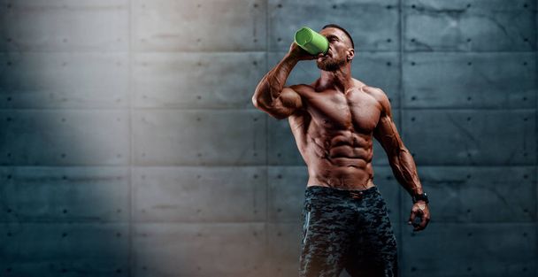Nutritional Supplement. Muscular Men Drinks Protein, Energy Drink After Workout - Photo, Image