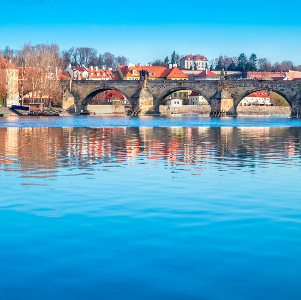 Prague, Charles bridge reflected in Vltava river - Photo, Image