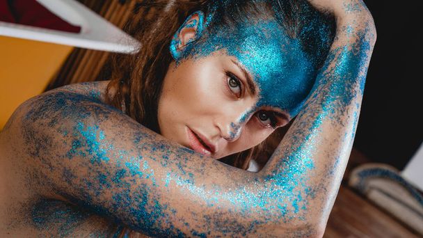 Portrait of beautiful woman with sparkles on her face. Girl with art make up - Fotografie, Obrázek
