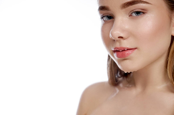 Model with drops of water on plump lips and face. - Photo, image