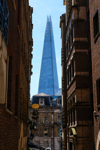 An exterior of The Shard seen from an alleyway in the CIty of London - Фото, изображение