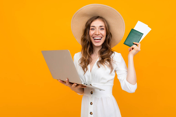 young woman with laptop and passport  - Fotó, kép