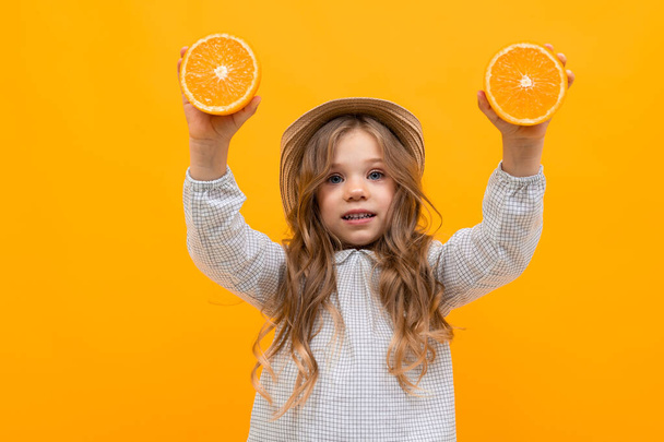 cute little girl posing against orange background - Фото, зображення
