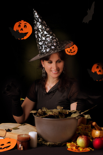 Witch practicing sorcery at Halloween night - Foto, imagen