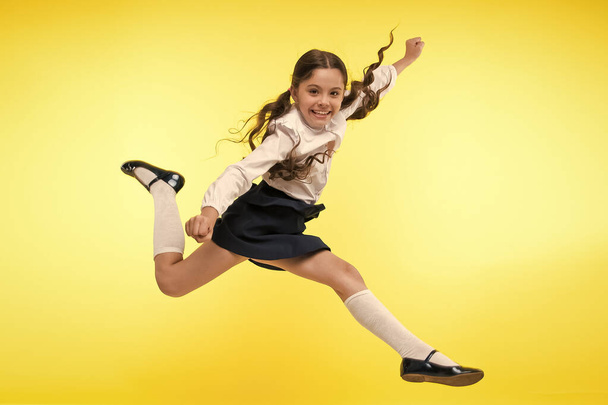 Toward knowledge. Girl make supernatural efforts on way to knowledge. Thirst of knowledge. Back to school. Kid cheerful schoolgirl full of energy jump in mid air. Pupil want study. Lets begin study - Foto, Imagen