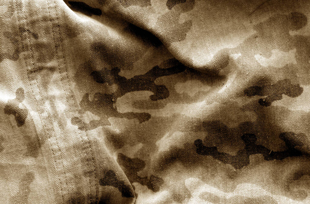 Dirty camouflage cloth with blur effect in brown tone. - Photo, Image