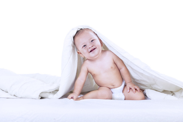 Adorable baby inside blanket - isolated - Zdjęcie, obraz